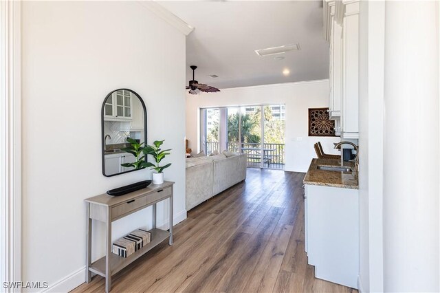 270 Delmar Ave, Fort Myers Beach, FL 33931 - hall featuring a sink, crown molding, wood finished floors, baseboards, and recessed lighting