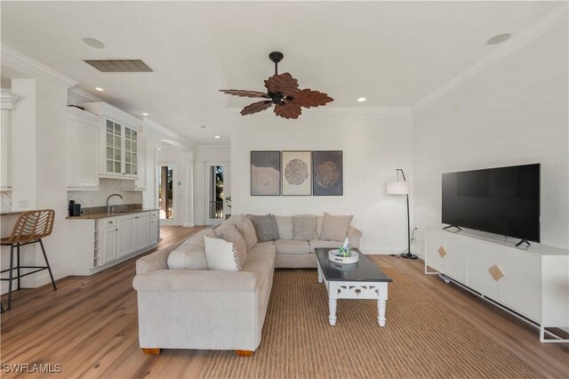 270 Delmar Ave, Fort Myers Beach, FL 33931 - living area featuring light wood-style flooring, ornamental molding, recessed lighting, ceiling fan, and baseboards