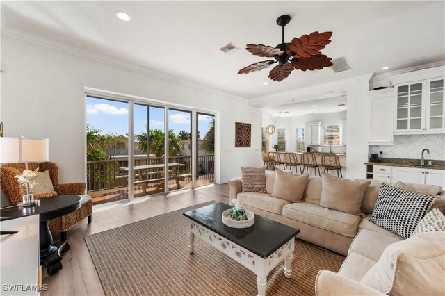 270 Delmar Ave, Fort Myers Beach, FL 33931 - living area featuring a ceiling fan, crown molding, wood finished floors, and recessed lighting