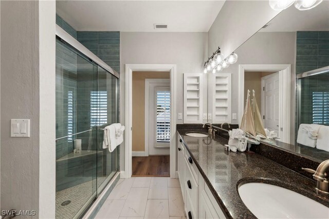 270 Delmar Ave, Fort Myers Beach, FL 33931 - bathroom featuring double vanity, a shower stall, and marble look tiles