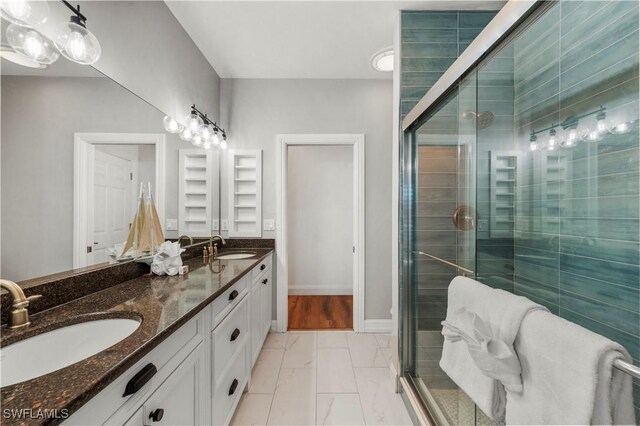 270 Delmar Ave, Fort Myers Beach, FL 33931 - bathroom featuring double vanity, marble finish floors, a shower stall, and baseboards