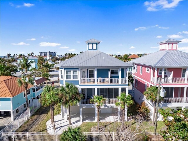270 Delmar Ave, Fort Myers Beach, FL 33931 - back of house featuring metal roof, a balcony, and a standing seam roof