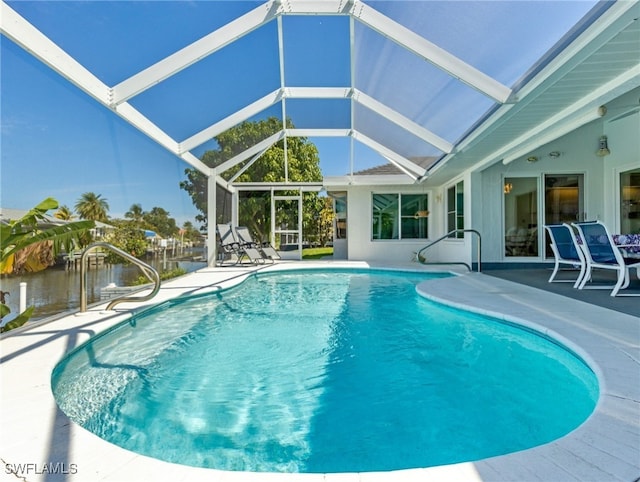 view of pool with a water view, a patio area, and a lanai