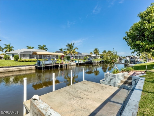 view of dock featuring a yard, a water view, and a lanai