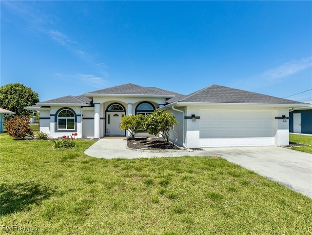 view of front facade with a front yard and a garage