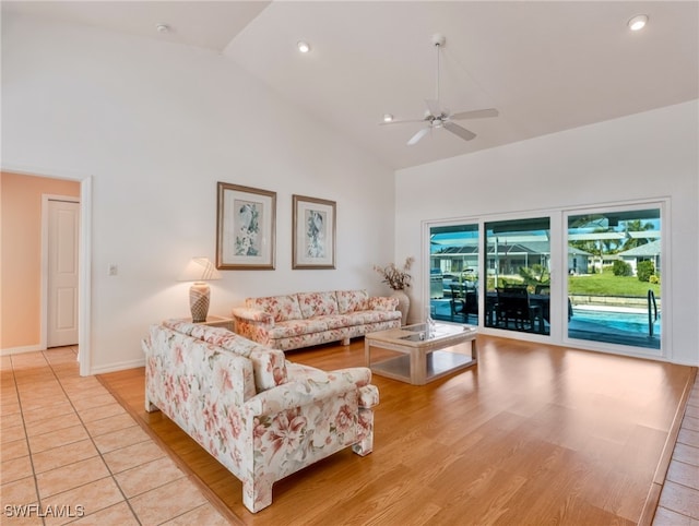 living room with high vaulted ceiling, light wood-type flooring, and ceiling fan