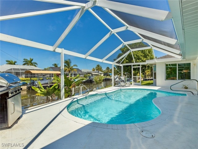 view of pool with a patio area, a lanai, and a water view