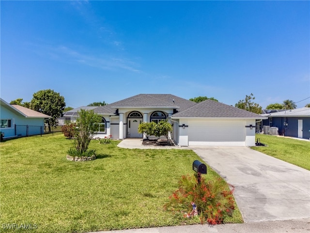 view of front of house with a garage and a front lawn