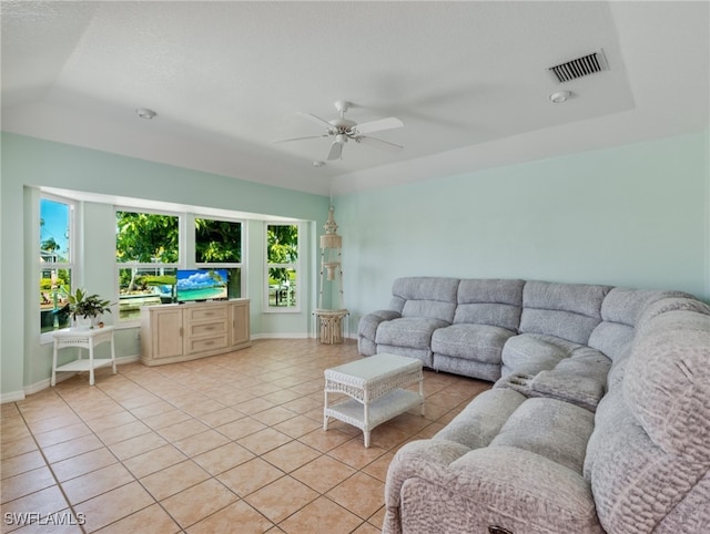 tiled living room with ceiling fan