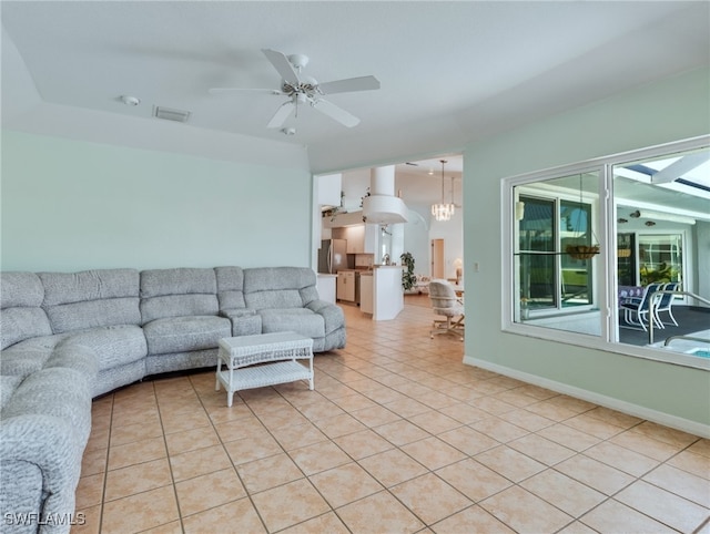 living room featuring light tile patterned floors and ceiling fan