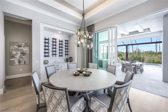 dining space featuring an inviting chandelier and light hardwood / wood-style floors