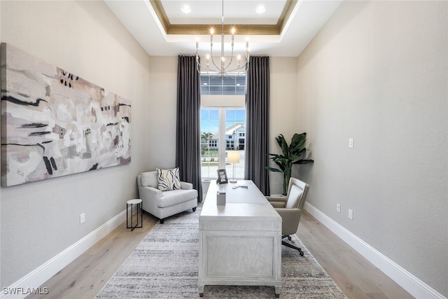 8903 Nevis Way, Naples, FL 34112 - office area featuring a raised ceiling, baseboards, light wood finished floors, and a chandelier