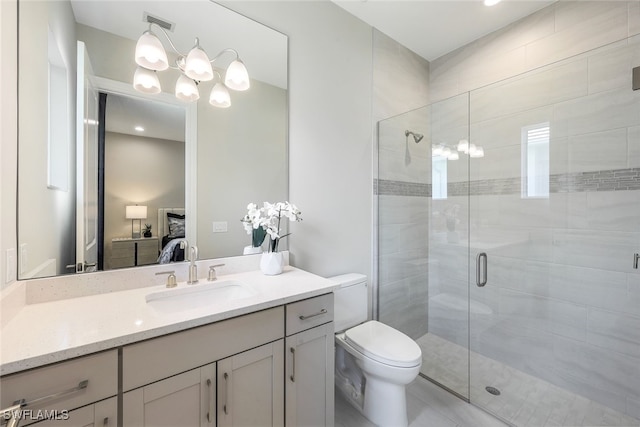 bathroom with vanity, toilet, and walk in shower