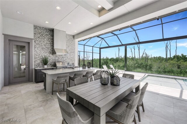 view of patio / terrace with area for grilling, a lanai, and sink