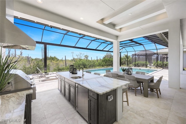 view of patio with an outdoor wet bar and a lanai