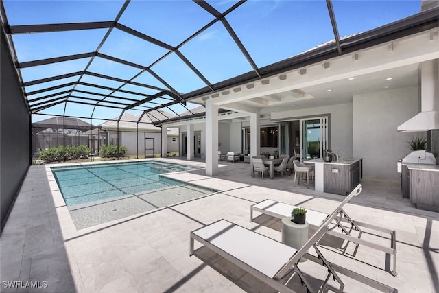 view of pool with a patio area and a lanai