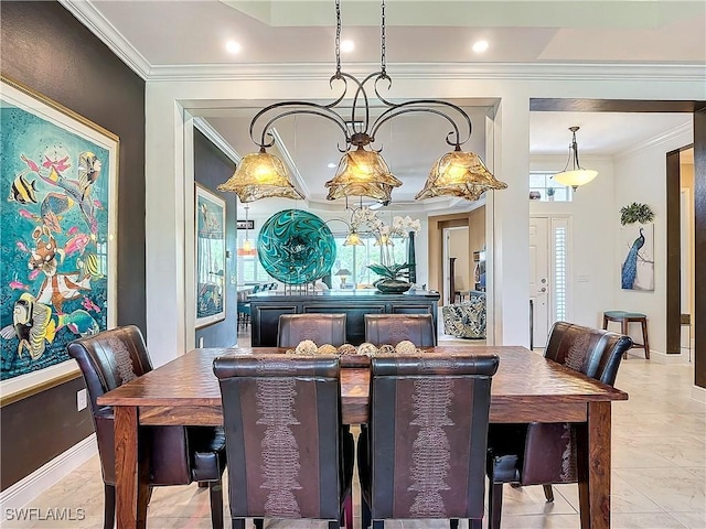 dining room with light tile patterned floors and crown molding