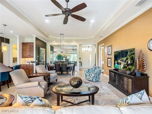 living room featuring light tile patterned floors, crown molding, a raised ceiling, and ceiling fan