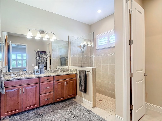 bathroom featuring vanity, tiled shower, and tile patterned floors