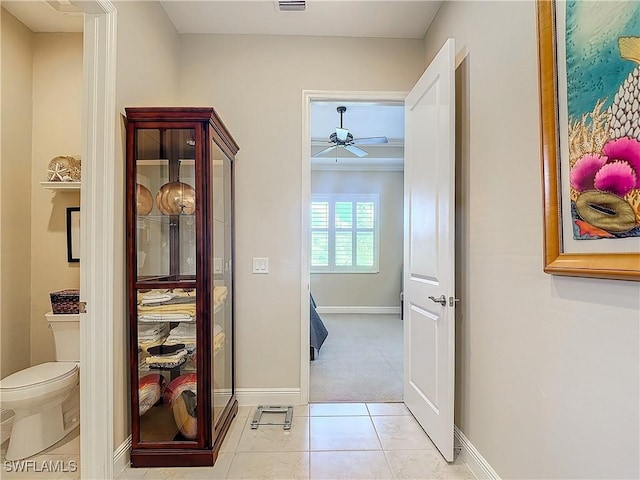 hall featuring light tile patterned floors