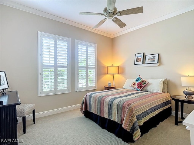 carpeted bedroom with ornamental molding and ceiling fan