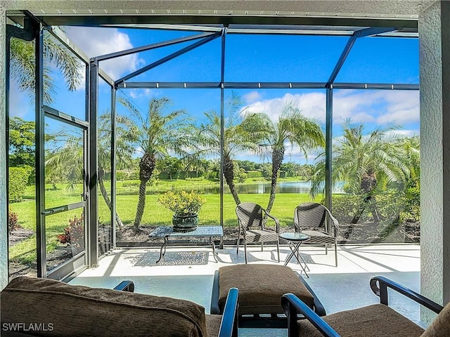 unfurnished sunroom with a water view