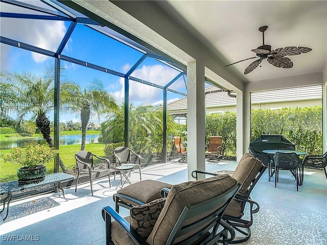 sunroom featuring a water view, a healthy amount of sunlight, and ceiling fan