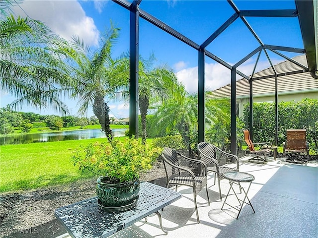 view of patio / terrace featuring a water view and a lanai