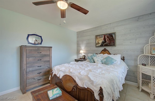 tiled bedroom featuring wooden walls and ceiling fan