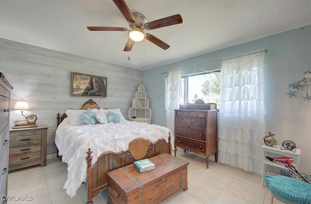 tiled bedroom with wooden walls and ceiling fan