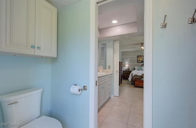 bathroom with toilet, vanity, tile patterned floors, and ceiling fan