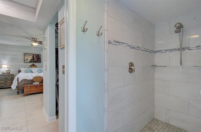 bathroom with a tile shower, tile patterned floors, and ceiling fan