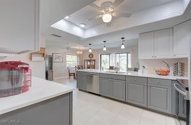 kitchen featuring white cabinets, appliances with stainless steel finishes, sink, gray cabinets, and decorative light fixtures