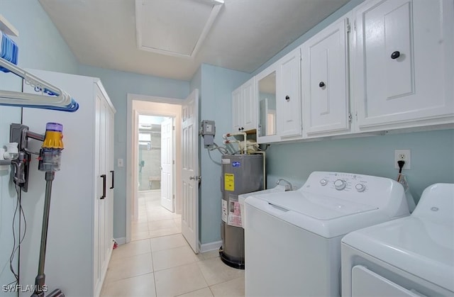 washroom with cabinets, independent washer and dryer, electric water heater, and light tile patterned flooring