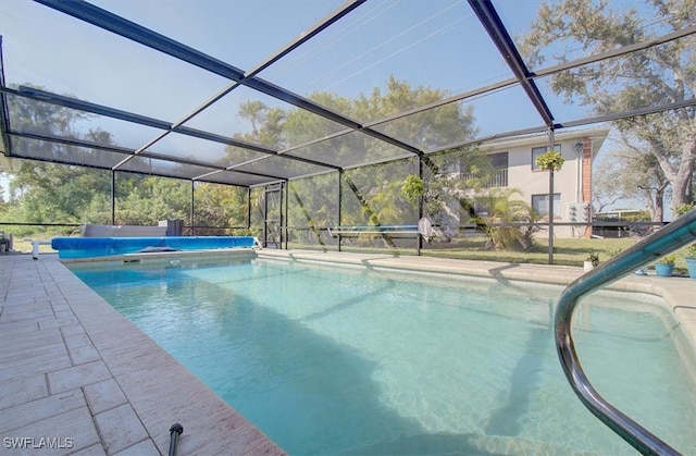 view of swimming pool featuring a lanai