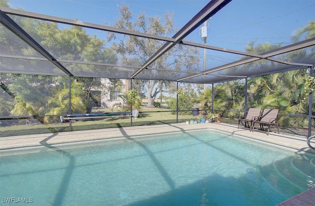 view of pool featuring a patio area and glass enclosure