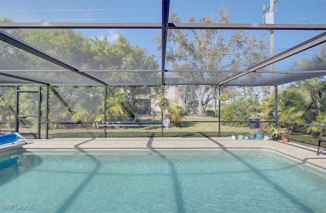 view of pool featuring glass enclosure