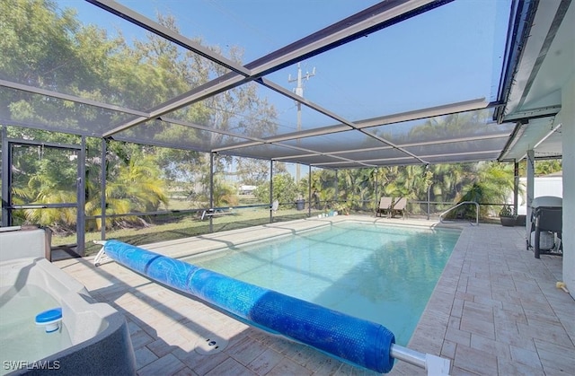 view of swimming pool featuring a patio area and glass enclosure