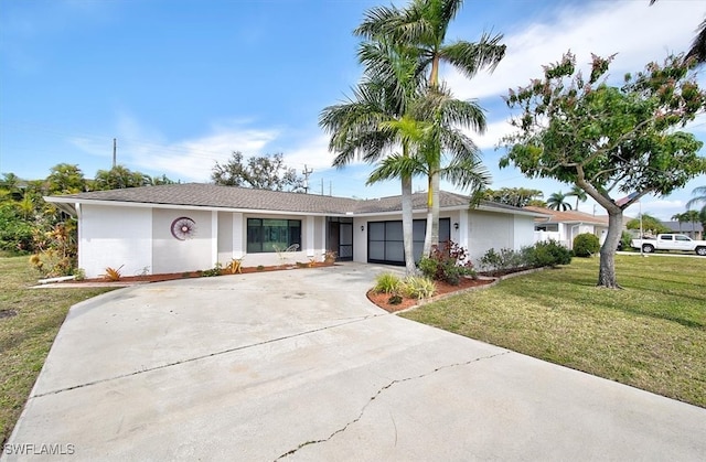 ranch-style home with a front lawn and a garage