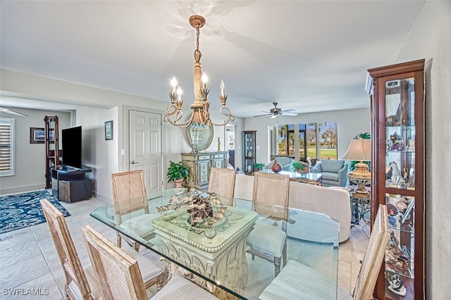 tiled dining area with ceiling fan with notable chandelier