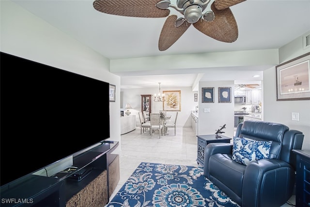 living room featuring light tile patterned flooring and ceiling fan with notable chandelier