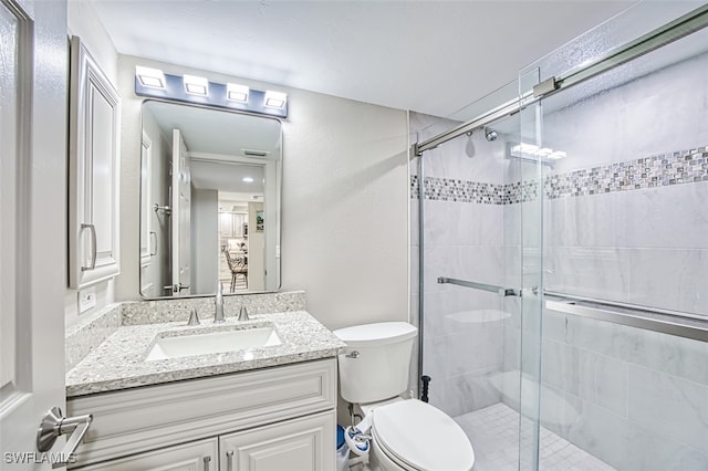 bathroom with vanity, toilet, and an enclosed shower