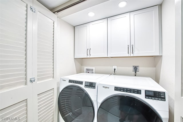 washroom featuring independent washer and dryer and cabinets