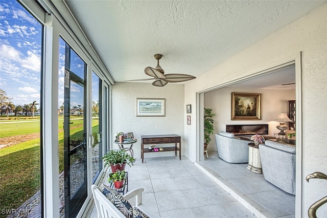 sunroom / solarium featuring ceiling fan