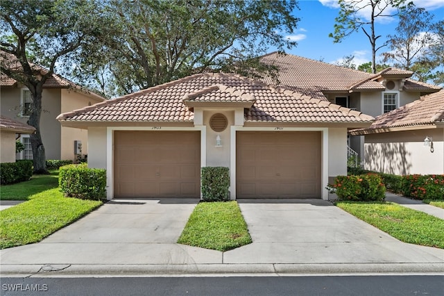 mediterranean / spanish-style home with a front yard and a garage