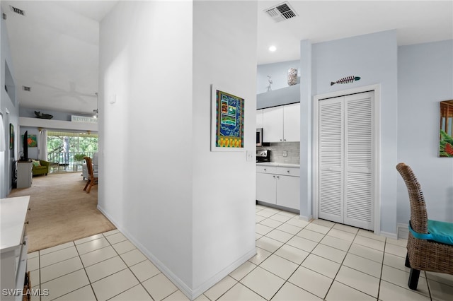 hallway featuring light carpet