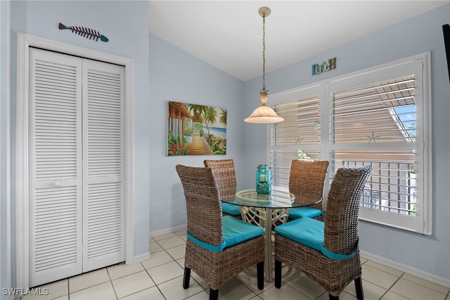 dining room with lofted ceiling and light tile patterned floors