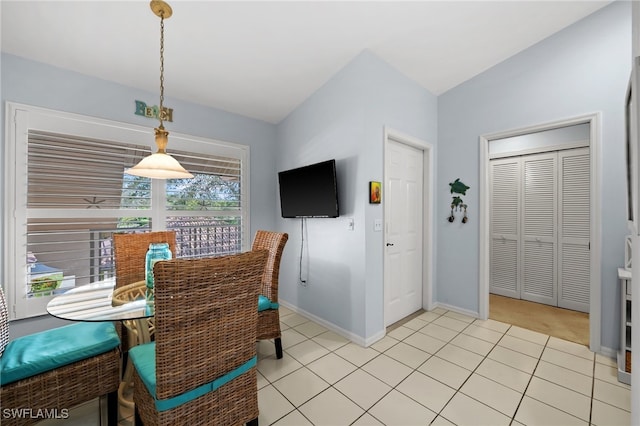 tiled dining area with lofted ceiling