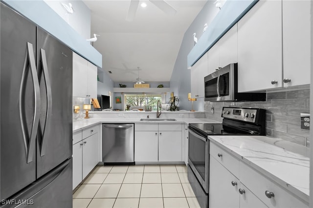 kitchen featuring appliances with stainless steel finishes, white cabinetry, and sink