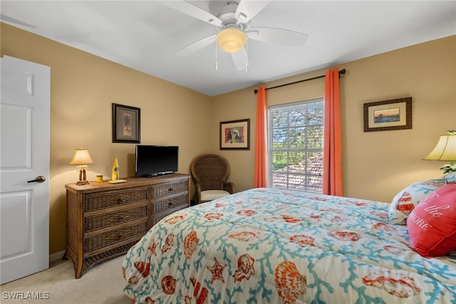 bedroom featuring ceiling fan and light carpet